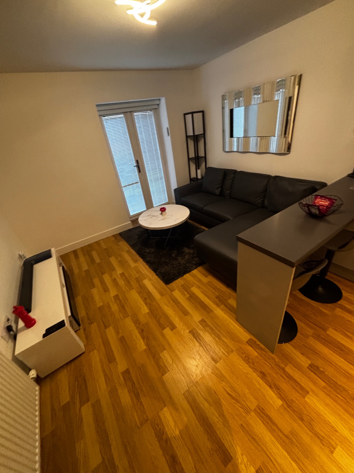 Living room after a NordSpark clean — polished wood floor and tidy seating